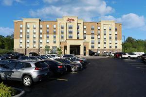 a large building with cars parked in a parking lot at Hampton Inn & Suites by Hilton Barrie in Barrie