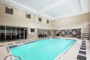 a large swimming pool in a large building with a large ceiling at Hampton Inn & Suites by Hilton Barrie in Barrie