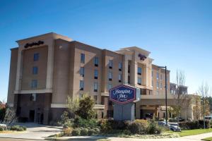 a large building with a sign in front of it at Hampton Inn Oxford/Conference Center in Oxford