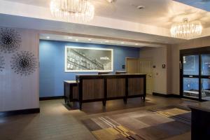 a lobby with a reception desk and chandeliers at Hampton Inn Oxford/Conference Center in Oxford