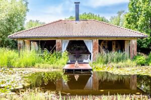 a small house with a reflection in a pond at Villa Irina in Paloznak