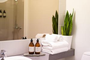 a bathroom with towels and bottles of wine on a counter at Hotel Aak in Åndalsnes +34 photos