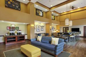 a living room with a couch and a dining room at Hampton Inn & Suites Murray in Murray