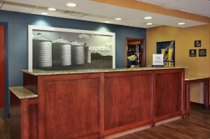a lobby with a reception counter with a picture on the wall at Hampton Inn & Suites Murray in Murray