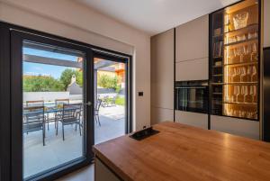a kitchen with a sliding glass door leading to a patio at Holiday house Vito Zadar in Zadar