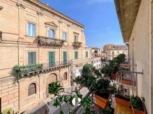 a view of an old building with plants on the balcony at Borgo Antico in Atessa