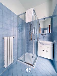 a blue tiled bathroom with a shower and a sink at Borgo Antico in Atessa