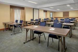 a classroom with tables and chairs in a room at Homewood Suites Hillsboro Beaverton in Beaverton