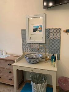 a bathroom with a sink and a mirror at Hotel Villa Anais in Prinos +47 photos