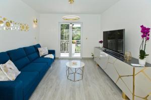 a living room with a blue couch and a table at Luxury Apartment Veronika in Hvar