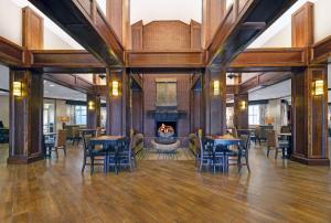 a large room with tables and chairs and a fireplace at Hampton Inn & Suites Pigeon Forge On The Parkway in Pigeon Forge