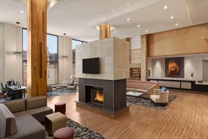 a living room with a fireplace and a tv at Homewood Suites University City Philadelphia in Philadelphia