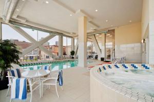 a swimming pool with a hot tub and a table and chairs at Homewood Suites University City Philadelphia in Philadelphia