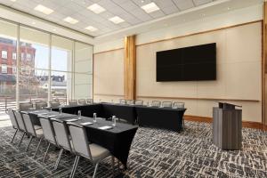 a conference room with tables and chairs and a flat screen tv at Homewood Suites University City Philadelphia in Philadelphia +35 photos