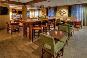 a dining room with tables and chairs in a restaurant at Hampton Inn Pittsburgh/West Mifflin in West Mifflin