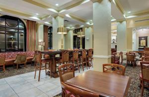 a restaurant with wooden tables and chairs in a room at Hampton Inn Pikeville in Pikeville