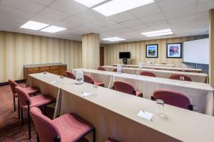 a conference room with tables and chairs and a screen at Hampton Inn Parkersburg/Mineral Wells in Mineralwells +26 photos