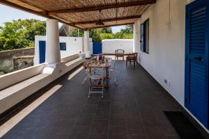 a patio with a table and chairs on a roof at La casa del Geologo in Stromboli