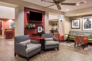 a waiting room with chairs and a flat screen tv at Hampton Inn Branson - Branson Hills in Branson
