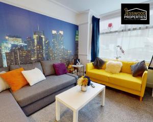 a living room with a couch and a yellow couch at Stylish 3 Bedroom House by Jesswood Properties Short Lets near M1 Luton Airport For Contractors & Business in Luton