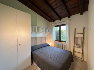 A bed or beds in a room at Le Terrazze: tra laghi e monti