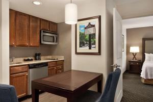 a small kitchen with a table in a hotel room at Homewood Suites by Hilton Dover - Rockaway in Dover