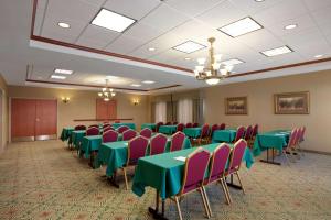 a conference room with green and pink tables and chairs at Hampton Inn Canon City in Canon City