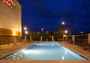 a swimming pool in front of a hotel at night at Hampton Inn Pennsville in Pennsville