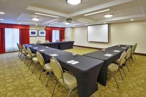 a conference room with a table and chairs and a screen at Hilton Garden Inn Portland Downtown Waterfront in Portland
