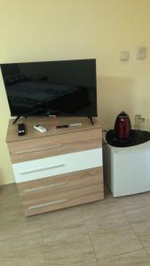 a flat screen tv sitting on top of a dresser at Петкови Лозенец in Lozenets