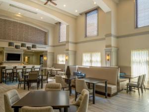 a restaurant with tables and chairs in a room at Hampton Inn Raynham-Taunton in Raynham
