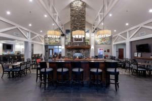 a bar in a restaurant with chairs and tables at Hampton Inn & Suites Raleigh Cary Lenovo Center in Cary