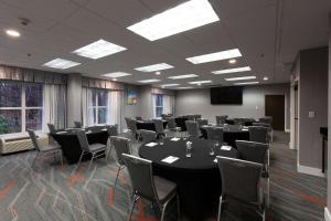 a conference room with tables and chairs and a screen at Hampton Inn & Suites Raleigh Cary Lenovo Center in Cary +51 photos