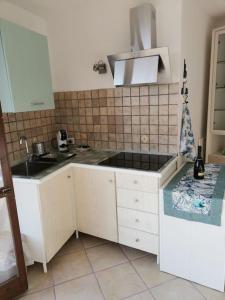 a kitchen with a sink and a counter top at Un Tuffo nel Blu in Sperlonga