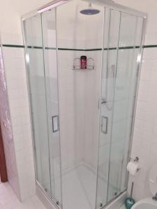 a shower with a glass door in a bathroom at Un Tuffo nel Blu in Sperlonga