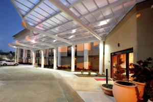 a large building with awning over a parking lot at Hampton Inn Raleigh/Durham Airport in Morrisville