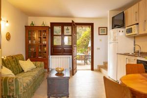 a living room with a couch and a table at Apartamentos La Güertona in Sardalla +26 photos