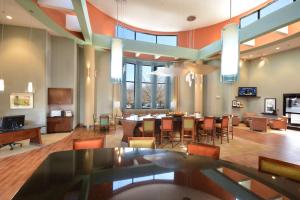 a lobby with a dining room and a dining table at Hampton Inn Raleigh/Durham Airport in Morrisville