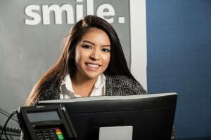 a woman is sitting in front of a computer at Hampton Inn Wilson Downtown in Wilson