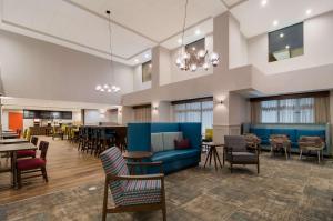 a lobby of a hospital with tables and chairs at Hampton Inn Wilson Downtown in Wilson