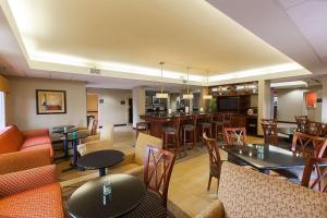 a restaurant with tables and chairs and a bar at Hampton Inn Raleigh/Garner in Garner