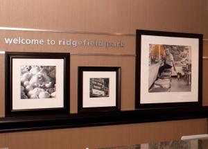 a group of framed pictures on a wall at Hampton Inn Ridgefield Park in Ridgefield Park