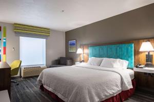 a hotel room with a large bed and a window at Hampton Inn Richfield in Richfield +22 photos