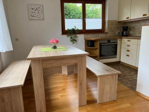 a kitchen with a wooden table and benches at Apartment Riedwiese in Hörbranz