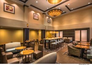 a restaurant with tables and chairs and a bar at Hampton Inn & Suites Reno in Reno