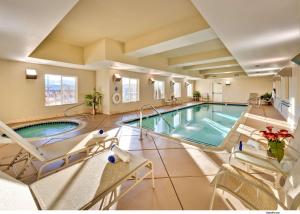a large indoor pool with chairs and a pool at Hampton Inn & Suites Reno in Reno