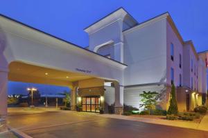 a large white building with a sign that reads covenant at Hampton Inn Brockport in Brockport