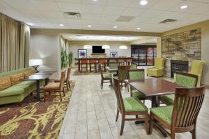 a waiting room at a hospital with tables and chairs at Hampton Inn Brockport in Brockport