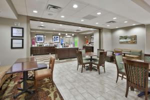 a waiting room with tables and chairs in a hospital at Hampton Inn Brockport in Brockport