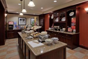 a kitchen with wooden cabinets and a counter top at Hampton Inn Rochester-Webster in Webster